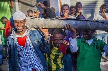 Merkato market workers with carpet